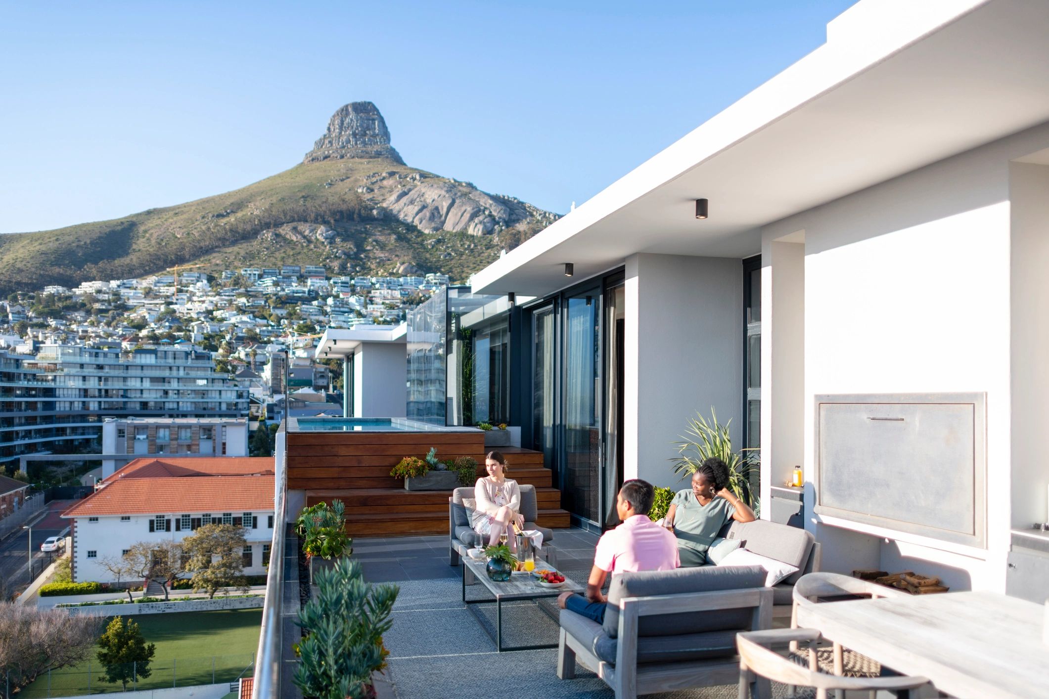 Group enjoying a premium travel experience with city and mountain views