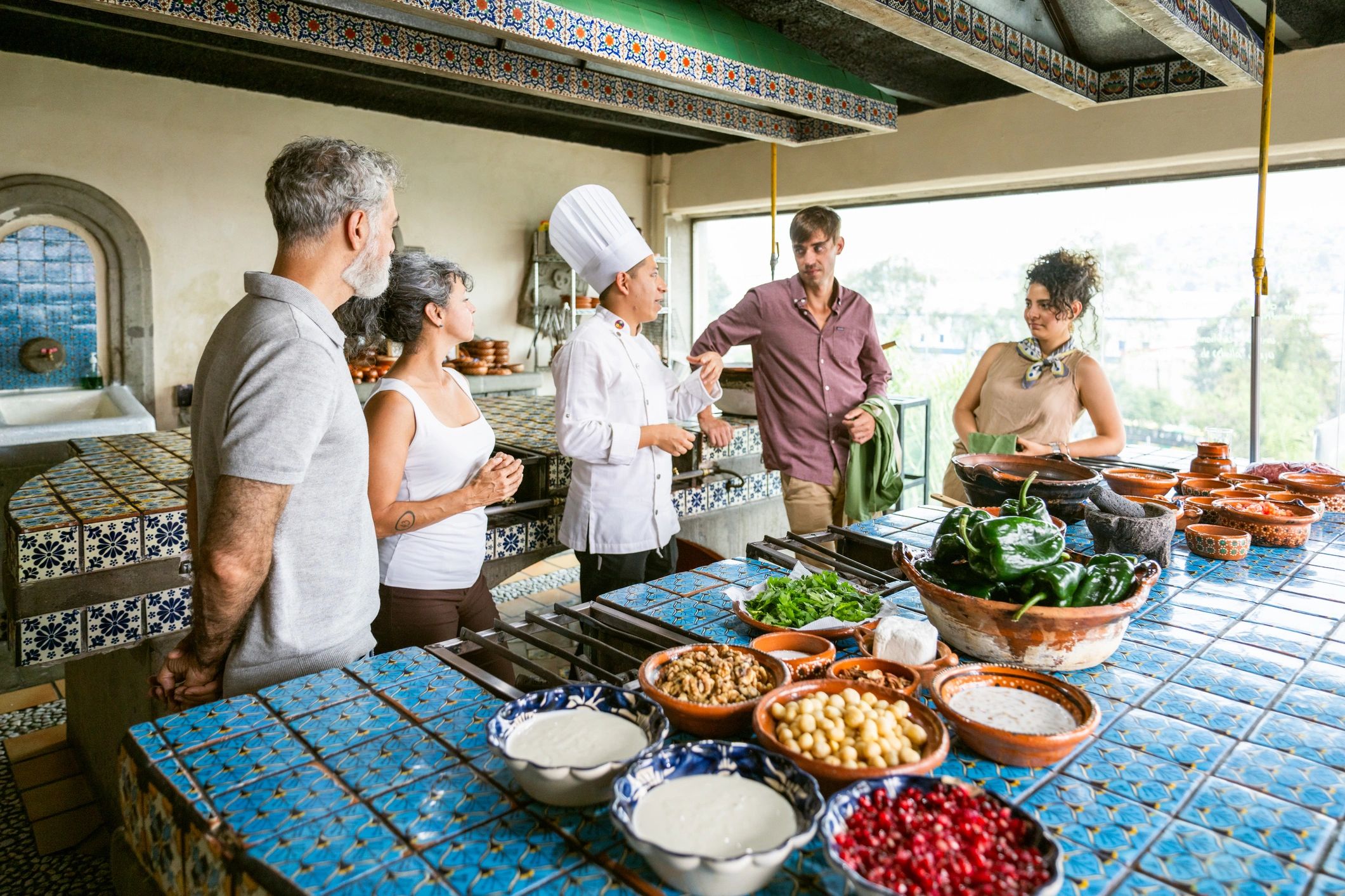 Chef shows tourists how to cook Mexican dish